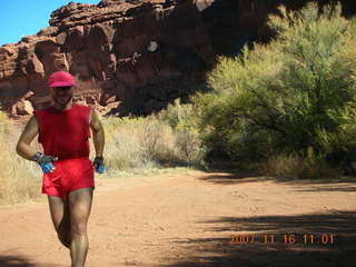 4 6bg. Canyonlands National Park - Lathrop Trail hike - Adam (tripod) running