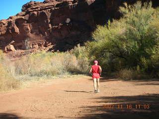 8 6bg. Canyonlands National Park - Lathrop Trail hike - Adam (tripod) running