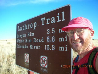 722 6bg. Canyonlands National Park - Lathrop Trail hike - Adam at trailhead sign