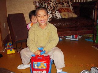Cecelia and Gaby riding the toy truck