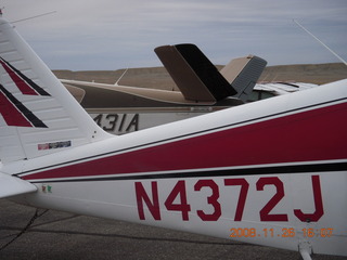 24 6ps. N4372J on the ground at Canyonlands Airport (CNY) next to a Beech Bonanza