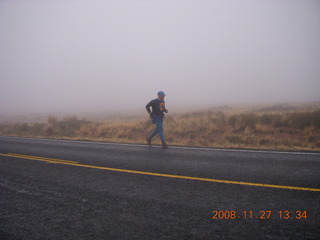 927 6pt. Canyonlands National Park - Lathrop trail hike - Adam running on the road in the rain