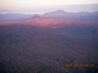 aerial - mountains near Red Creek with strip of sun