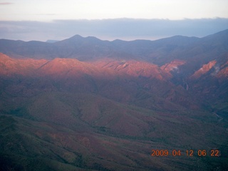 aerial - mountains near Red Creek with strip of sun
