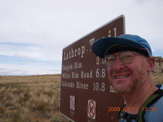 1011 6uh. Canyonlands - Lathrop trail hike - Adam at trailhead sign