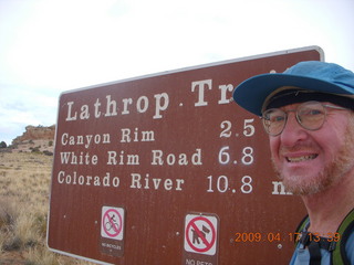 1012 6uh. Canyonlands - Lathrop trail hike - Adam at trailhead sign
