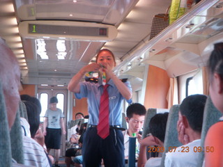 China eclipse - Hangzhou to Shanghai train ride - lady selling toys