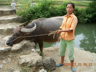 111 6xr. China eclipse - Yangshuo bicycle ride - lady with water buffalo