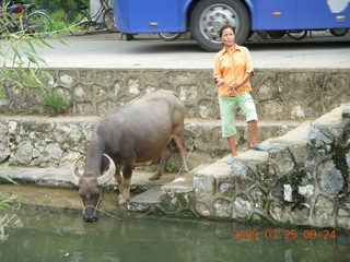 122 6xr. China eclipse - Yangshuo bicycle ride - walk to farm village - lady with water buffalo