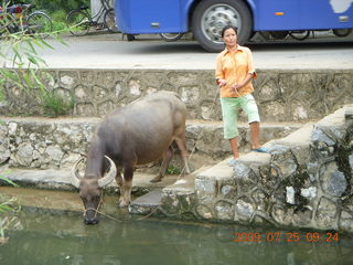 China eclipse - Yangshuo bicycle ride - lady with water buffalo