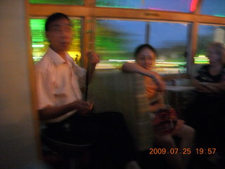 China eclipse - Guilin evening boat tour - musician on odd instrument