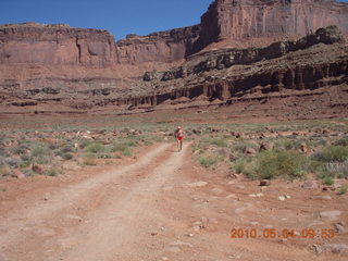 1205 774. Canyonlands Lathrop Trail hike - Adam running on white rim road