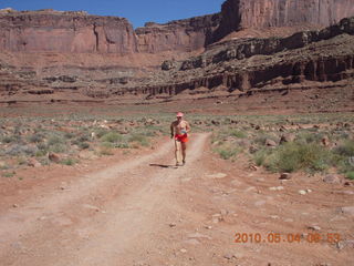 1206 774. Canyonlands Lathrop Trail hike - Adam running on white rim road