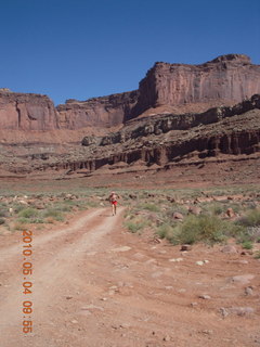 1211 774. Canyonlands Lathrop Trail hike - Adam running on white rim road