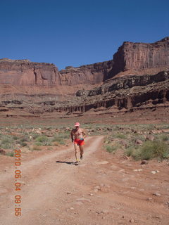 1212 774. Canyonlands Lathrop Trail hike - Adam running on white rim road