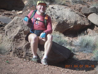 1405 7j7. Canyonlands Lathrop hike - Adam sitting on neat rock (tripod)