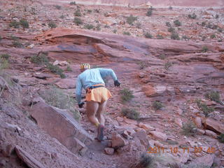 1677 7qb. Canyonlands National Park - Lathrop trail hike - Adam hiking - back (tripod)
