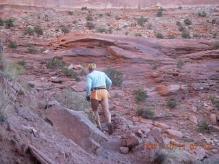 1679 7qb. Canyonlands National Park - Lathrop trail hike - Adam hiking - back (tripod)