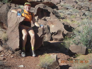 1691 7qb. Canyonlands National Park - Lathrop trail hike - Adam sitting in 'rock chair'