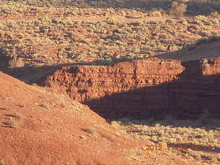 Monument Valley tour - Adam holding up cube rock, Atlas style