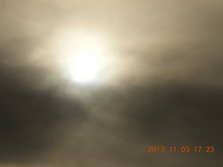 Uganda - eclipse site - sun behind clouds