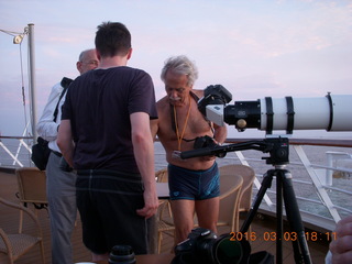 folks watching sunset from ship