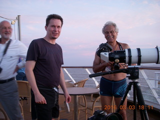 folks watching sunset from ship