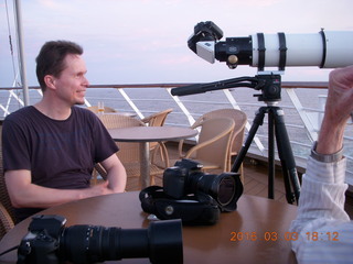 folks watching sunset from ship