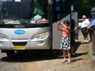 350 99d. Indonesia - Bali - bus ride - Iris taking a picture of monument