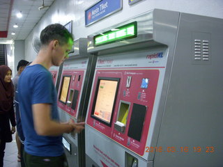Malaysia - Kuala Lumpur food tour - Mathieu buying subway tickets