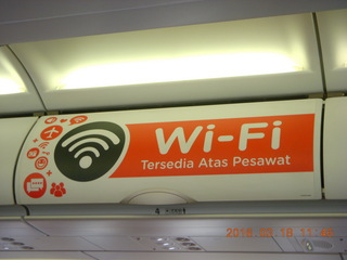 Air Asia airplane with ads on the luggage racks