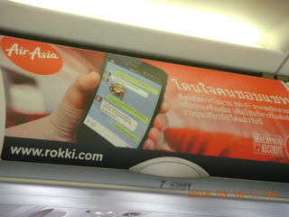 Air Asia airplane with ads on the luggage racks