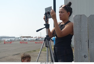 44 9sm. Riverton Airport - lady taking eclipse pictures