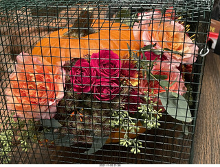 pumpkin flower arrangement in a cage