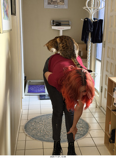 Ashley Saenz and cat Pickle on her back