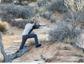 454 a2q. Utah - Canyonlands National Park - Mesa Arch hike - Tyler taking a picture